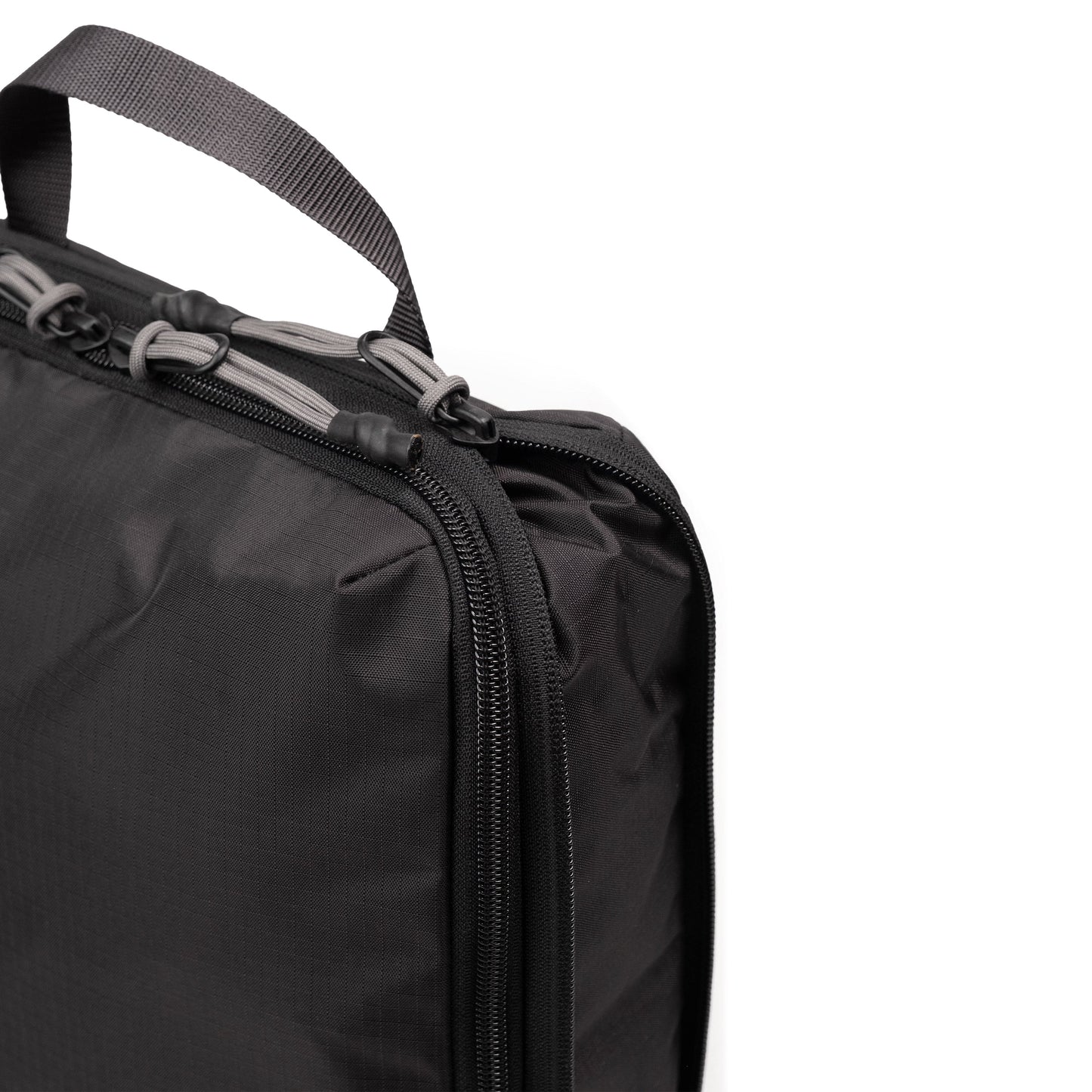 Zipper detail white background image of Topo Designs Global Compression Pack Bag Set in "Black / Black"