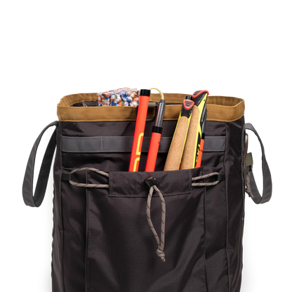 General detail shot of Topo Designs Mountain Gear Bag in "Black / Neutral" with side pocket packed out.