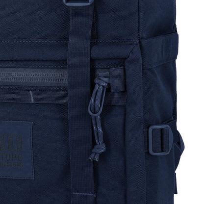 General detail Shot of the Topo Designs Rover Pack Tech in "Navy" showing front logo patch, zipper pulls, and daisy chain webbing.